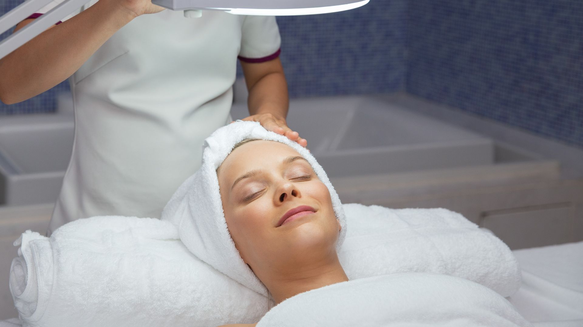 Happy Woman Relaxing after Facial Treatment in Spa Mediskin
